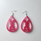 Translucent resin teardrop rabbit dangle earrings with colorful glitter on stainless steel hooks.