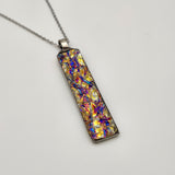 Pink titanium burl dichroic pendant with iridescent Dichrolam resin on stainless steel chain