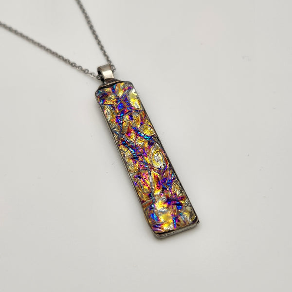 Pink titanium burl dichroic pendant with iridescent Dichrolam resin on stainless steel chain