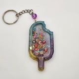 Popsicle shaker keychain filled with oil and moving charms.