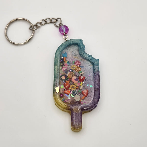 Popsicle shaker keychain filled with oil and moving charms.