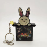 Rabbit in a hat shaker keychain filled with oil and moving charms.