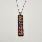 Red burl dichroic pendant with iridescent Dichrolam resin on stainless steel chain