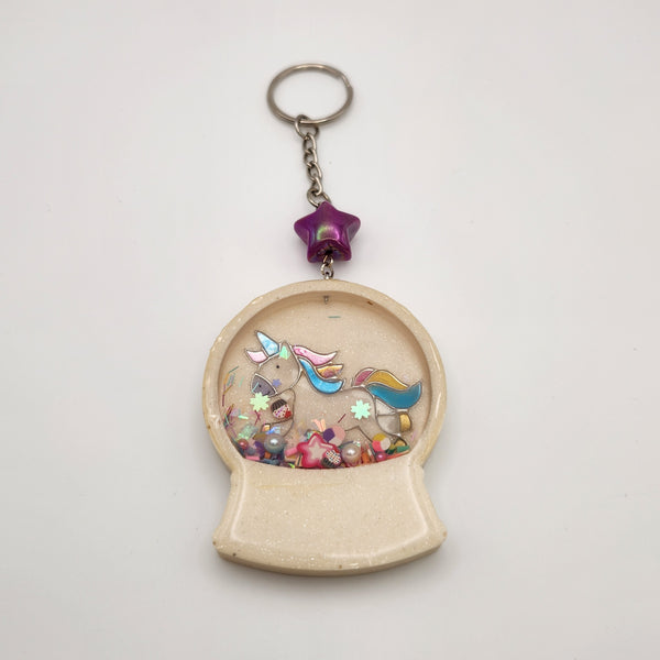 Snowglobe shaker keychain filled with oil and moving charms
