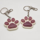 Hand-poured resin pawprint keychain supporting animal rescue