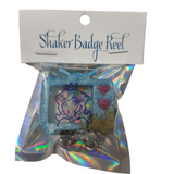 Retro-style TV shaker badge reel with floating charms