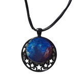 Round metal crescent moon and star pendant with resin center on a leather cord.