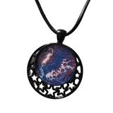 Round metal crescent moon and star pendant with resin center on a leather cord.