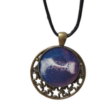 Round metal crescent moon and star pendant with resin center on a leather cord.