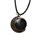 Double-sided resin moon necklace with brass crescent and black cord chain