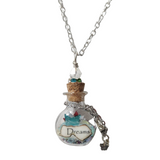 Round glass bottle necklace filled with magical items on stainless steel chain