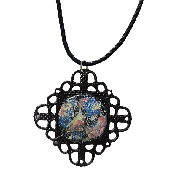 Hand-painted space pendant with resin coating in black metal frame.