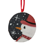 Hand painted wood slice ornament featuring a snowman with a red hat and scarf with a navy background with snowflakes.
