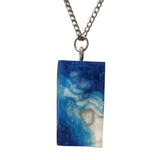 Multi-depth resin island pendant with layered land and water design