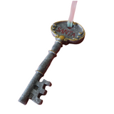 A resin ornament in the shape of a key with 'Santa' , hanging from a ribbon.
