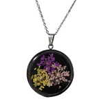 1-inch wood pendant with real dried flowers sealed in resin on stainless steel chain.