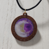 1.5 inch round wood pendant with resin-filled center on leather cord